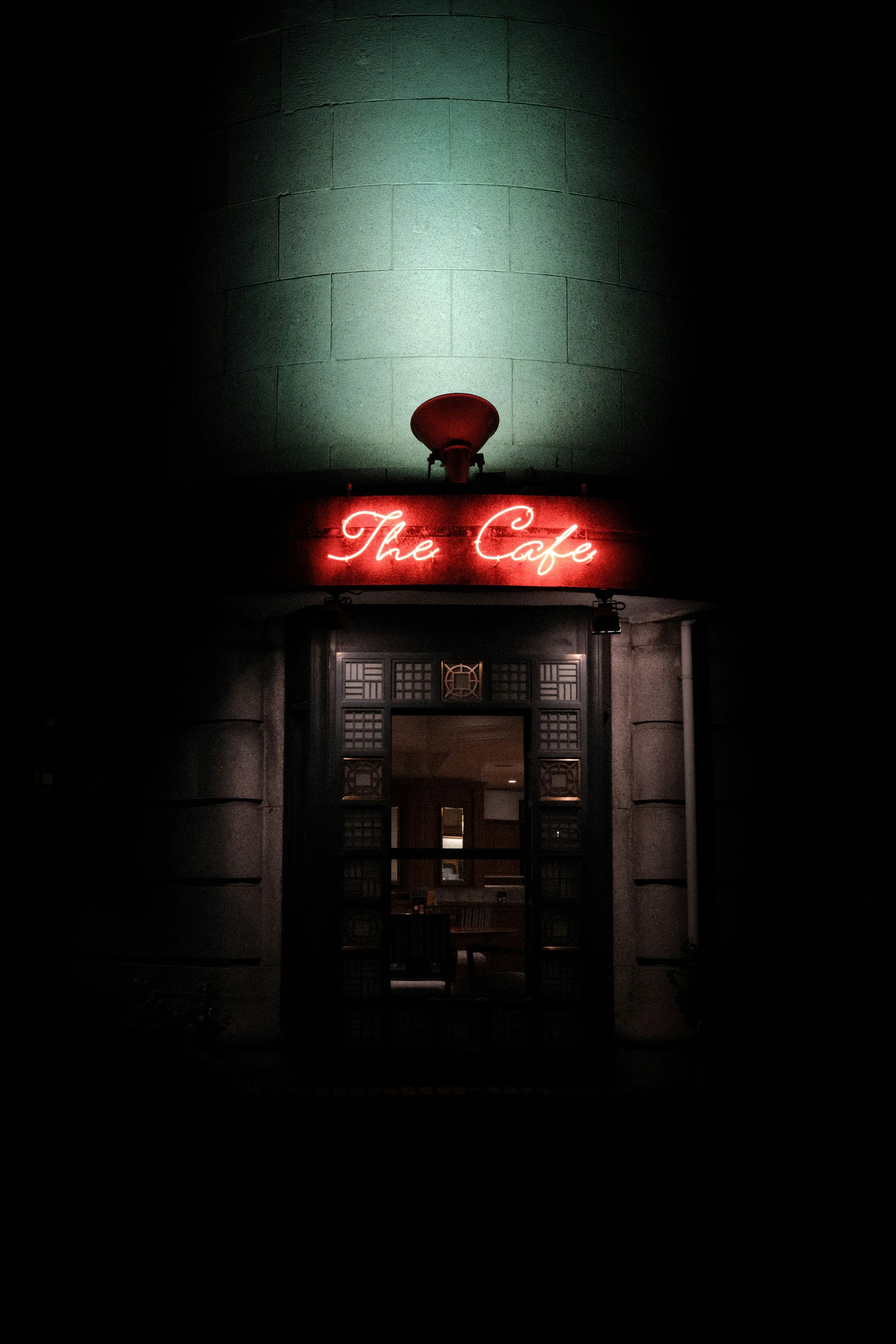 A neighbourhood café glowing at night