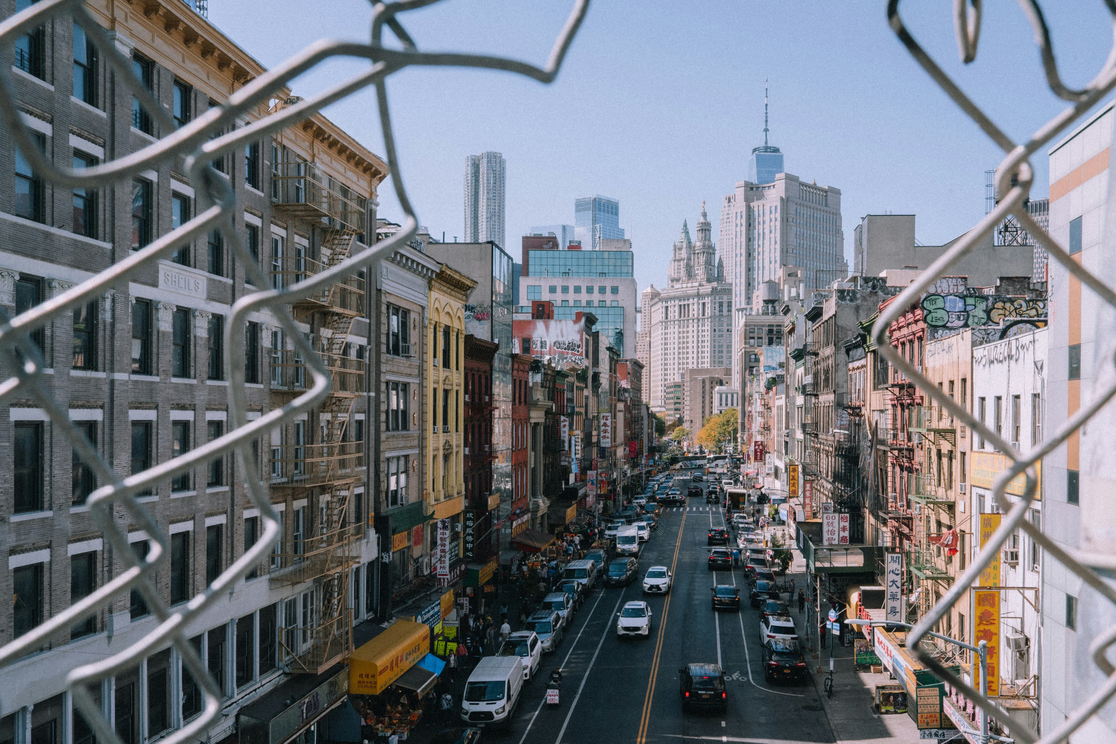 A New York neighbourhood viewed through a street fence